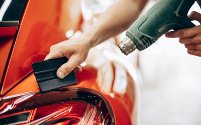 Car wrapping with foil and drying with fan at car service