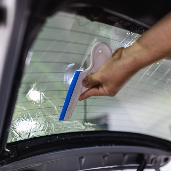 [freepicdownloader.com]-car-tinting-worker-applying-tinting-foil-car-window-large